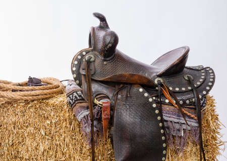 Studio shot of saddle on a hay baleの写真素材