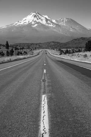 Two lane road heads west across California Mountain Landscapeの写真素材
