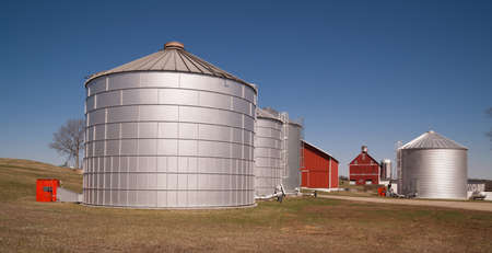 Storage silos sit in waiting to be filled on the farmの写真素材