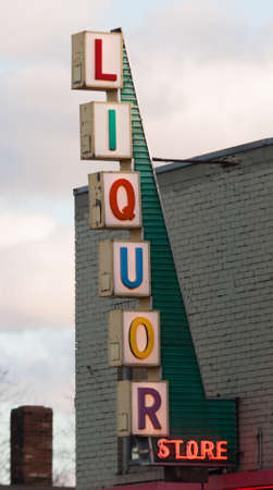 Vertical Liquor Store Sign Brick Wall Outside Advertisementのeditorial素材