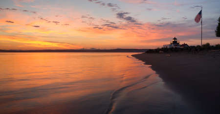 The United States Flag waves in the early morning on Puget Soundの写真素材