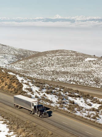 18 Wheeler gains ground down interstate highway in mountainous Washington Stateの写真素材