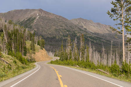 The highway winds along thru vast peaks on East Entrance Road in Yellowstone