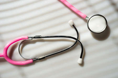 Window light washed over a Stethoscope in the doctors officeの写真素材