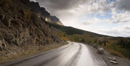 It's just starting to rain on the road in Glacier National Parkの写真素材