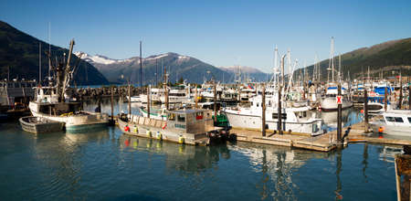 WHITTIER, ALASKA/UNITED STATES â AUGUST, 5: Boats are moored at the marina and are very protected in this harbor surrounded by mountains on 08/20/15 in Whittier, AK.のeditorial素材