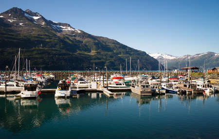 WHITTIER, ALASKA/UNITED STATES â AUGUST, 5: Boats are moored at the marina and are very protected in this harbor surrounded by mountains on 08/20/15 in Whittier, AK.のeditorial素材