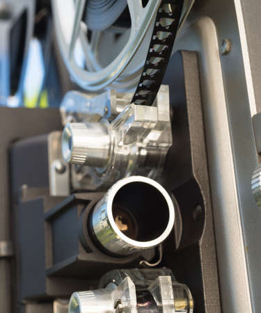 A large film reall is mounted on a vintage Super 8 movie projectorの写真素材