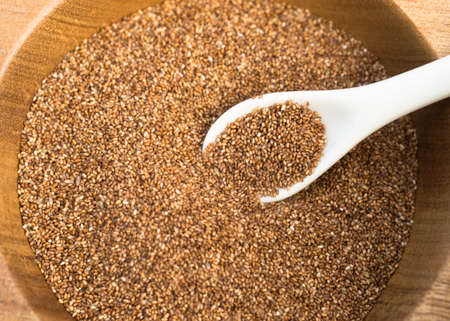 A spoon white sits in a bowl of Red Wheatの写真素材
