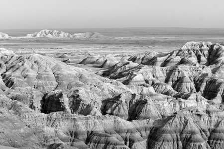 Clouds allow the sun to light rock formations in the South Dakota Badlandsの写真素材