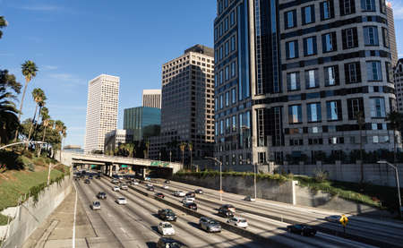 Automobiles and commuters travel through downtown Los Angeles on the freewayのeditorial素材