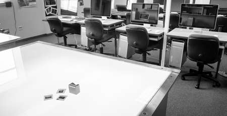 Monochrome representation of a college graphic design classroom with light table and slidesの写真素材
