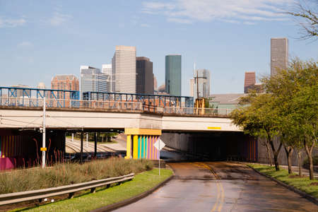 Trees budding Springtime road leads to the urban jungle of Houston, Texasの写真素材