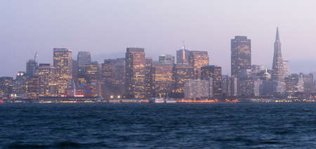 Common mist and fog hangs over the San Francisco skyline after sunsetの写真素材