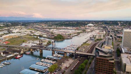Mt Rainier stands in the background above the tide flats and the Port of Tacoma