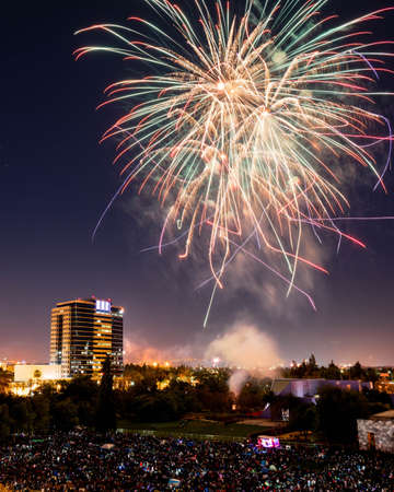 People gather to watch the fireworks in Discovery Meadow Park in San Jose Californiaの写真素材