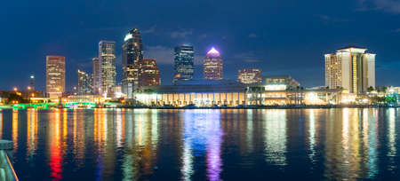 Night falls as lights come up on buildings beginning a beautiful summer evening in Tampa Florida downtownのeditorial素材
