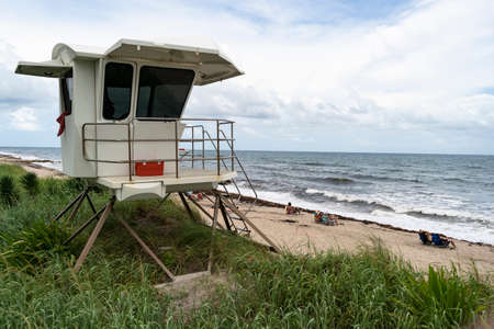 A towel hangs over the window of an elevated coast life guard hut shack Palm Beach Floridaのeditorial素材
