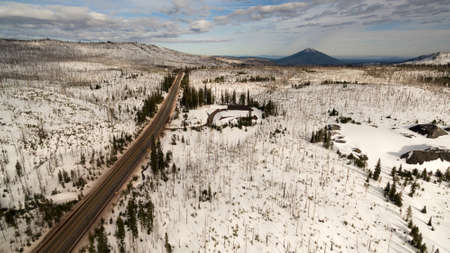 Winter snow covers the ground around Oregon highway 20 headed to Black Butte Mountainの写真素材