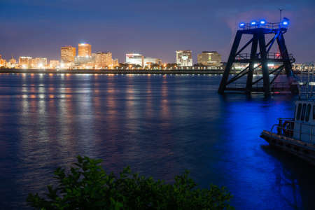 Night falls as building lights begin to glow Baton Rouge Louisiana and the Mississippi Riverのeditorial素材