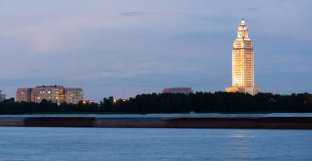 Horizontal composition covering the Mississippi River waterfront barge traffic and the State Capitol of Louisiana at Baton Rougeのeditorial素材