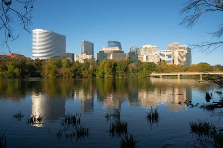 The smooth flowing Potomac River reflects the buildings of Alexandria Virginiaの写真素材