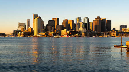 Light reflects of the glass in buildings in the urban downtown city center core skyline of Boston Massachusettsの写真素材