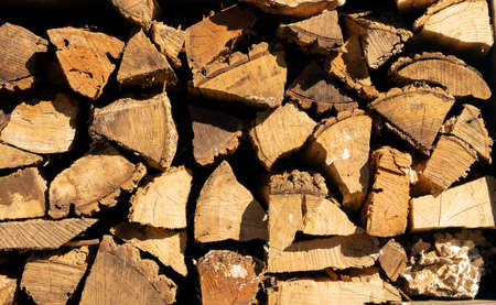 Big pieces of dried cured firewood piled high ready to burnの写真素材