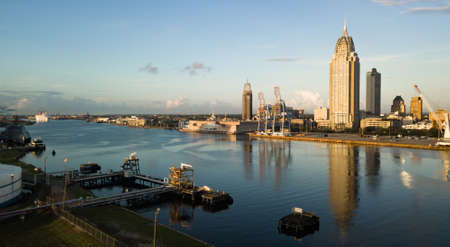 Beautiful blue skies over the downtown city center in an aerial view of Mobile Alabamaの写真素材
