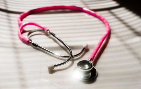 Window light washed over a Stethoscope in the doctors officeの写真素材