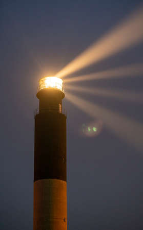 The Oak Island lighthouse beams light out 360 degrees on Caswell Beachの写真素材
