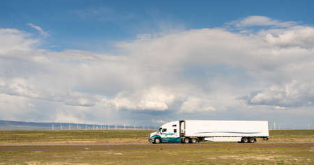 White big rig semi truck with cargo trailer on a Utah Highwayの写真素材