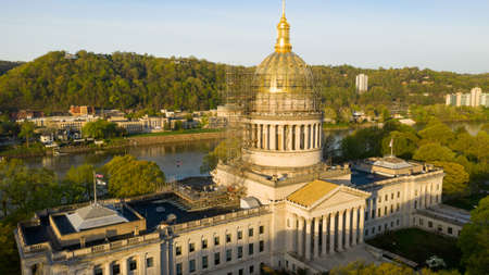 Empty scaffolding surrounds the entire golden dome at sunrise at the Charleston West Virgina State Capitalの写真素材
