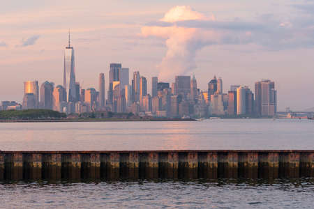 Manhattan is one of 5 Burroughs that make up New York City shown here at sunsetの写真素材