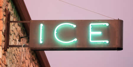 A metal and glass neon sign advertises iceの写真素材