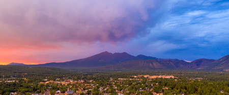 Blue and Orange color swirls around in the clouds at sunset over Flagstaff Arizonaの写真素材