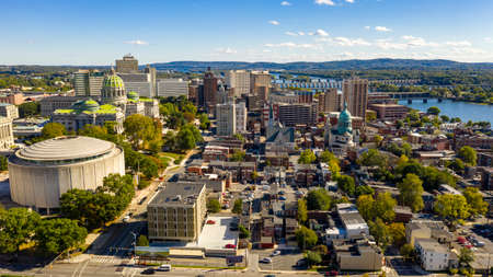 Afternoon light hits the buildings and downtown city center area in Pennsylvania state capital at Harrisburgの写真素材