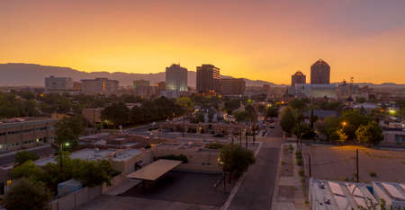 Saturated orange hue appears behind Albuquerque New Mexico at sunriseの写真素材