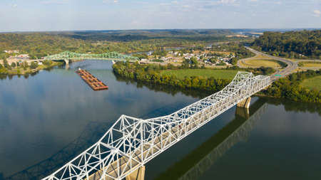 A river Tugboat pushes barge contents down the Ohio River south of Henderson West Virginiaの写真素材