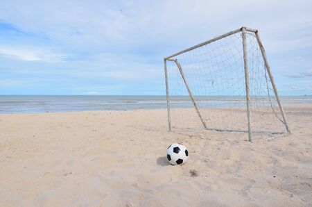 Scene of football stop in front of the goal at the beachの写真素材