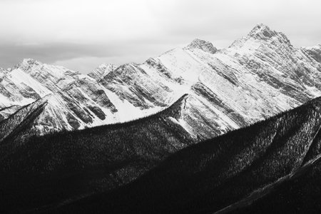 Black and white image of snow-capped mountains in winter.の写真素材