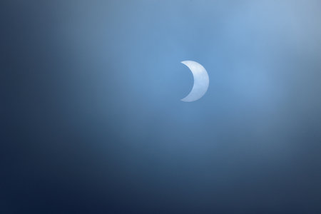 Crescent moon in the blue sky, closeup of photo.の写真素材