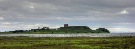 Middle age ruin of castle situated on an isolated islandの写真素材