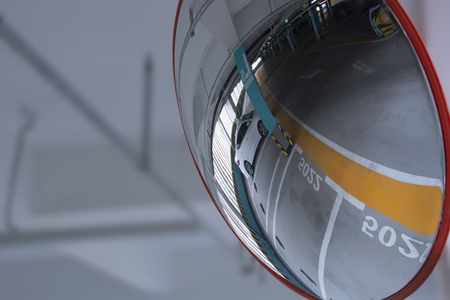 Parking lot reflecting in convex mirrorの写真素材