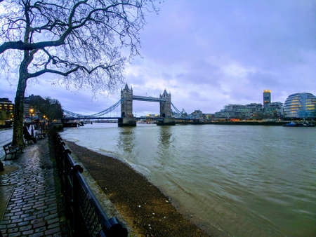 Tower Bridge and the Thames River at dusk in London, UK