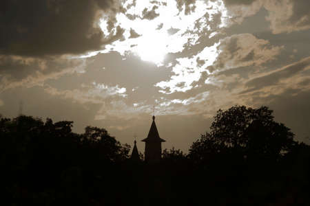 Silhouette of trees and church tower