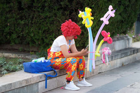 Woman clown selling balloons