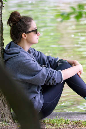 Young girl relaxing near lake