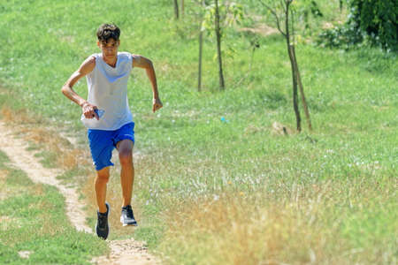 Young boy running on pathway in the nature