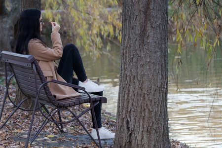 Girl sitting on bench in park